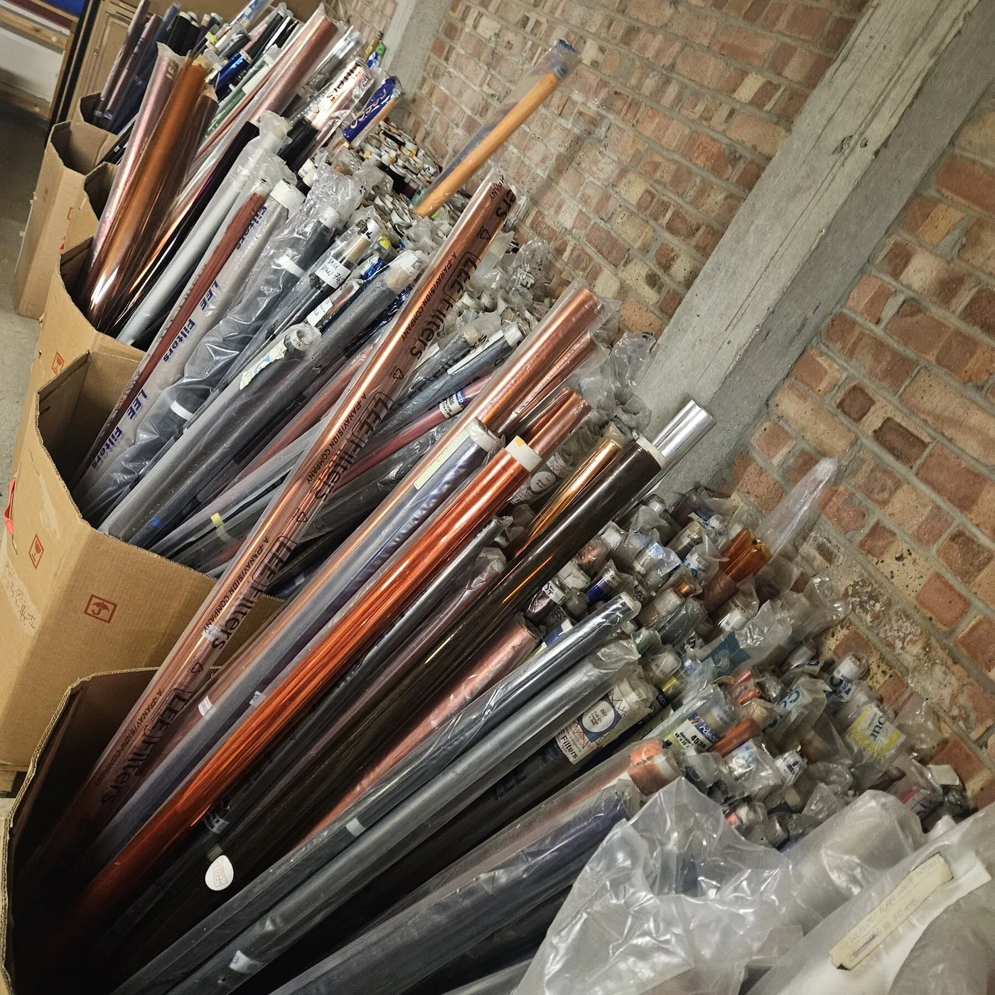 Boxes of rescued fabric rolls and materials stored in the Scrapstore